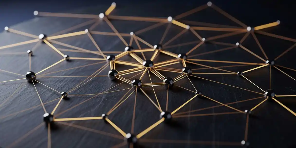 Glowing amber threads connecting polished metal data nodes on a dark slate surface, with warm gold light reflecting from the central cluster.